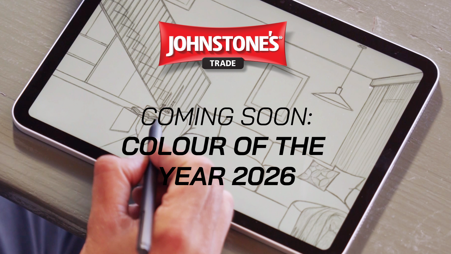 A hand uses a stylus on a tablet displaying an interior design sketch, with the Johnstone’s Trade logo and the text “COMING SOON: COLOUR OF THE YEAR 2026” at the top.
